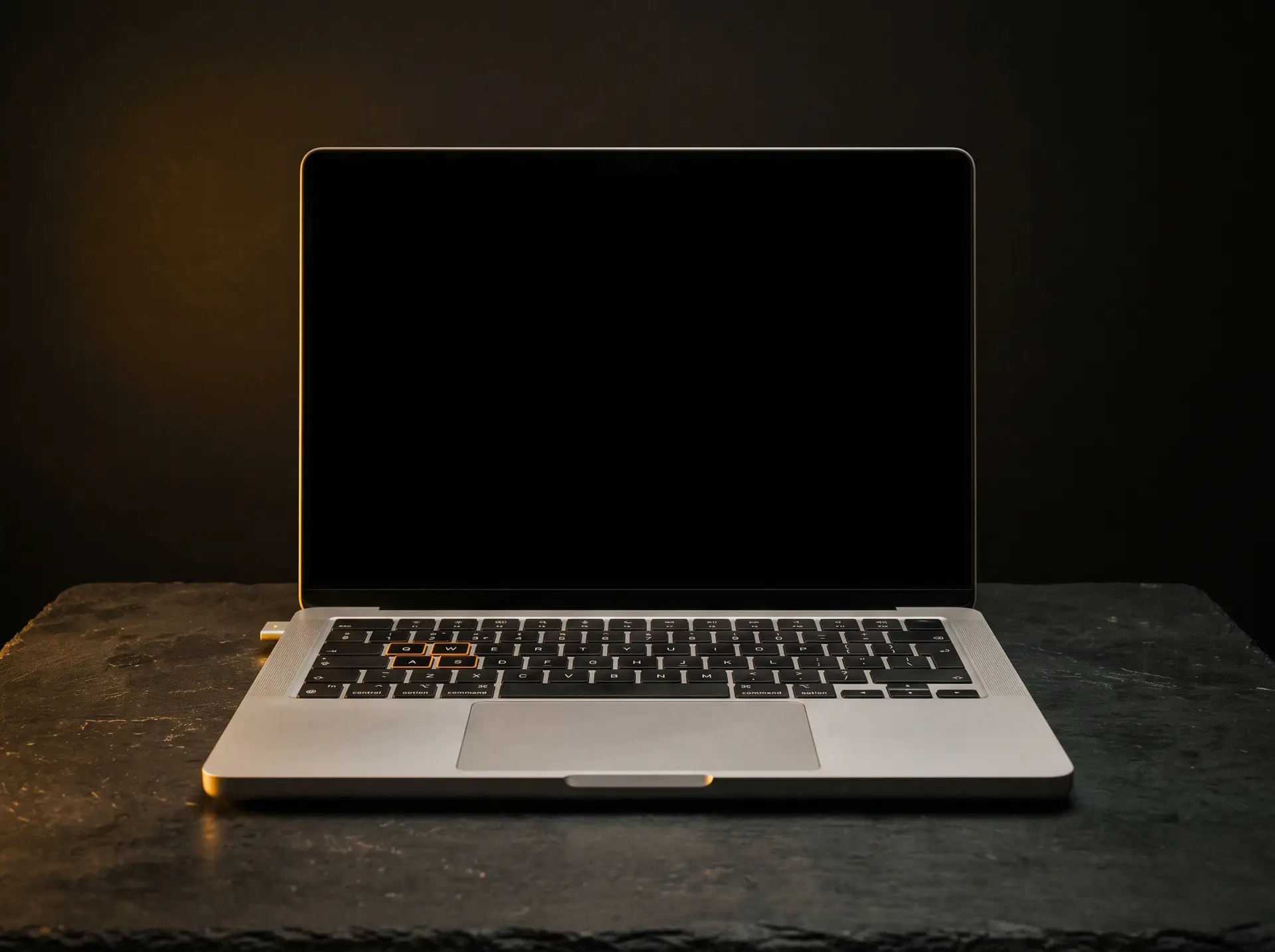 A laptop photographed straight on, screen blank