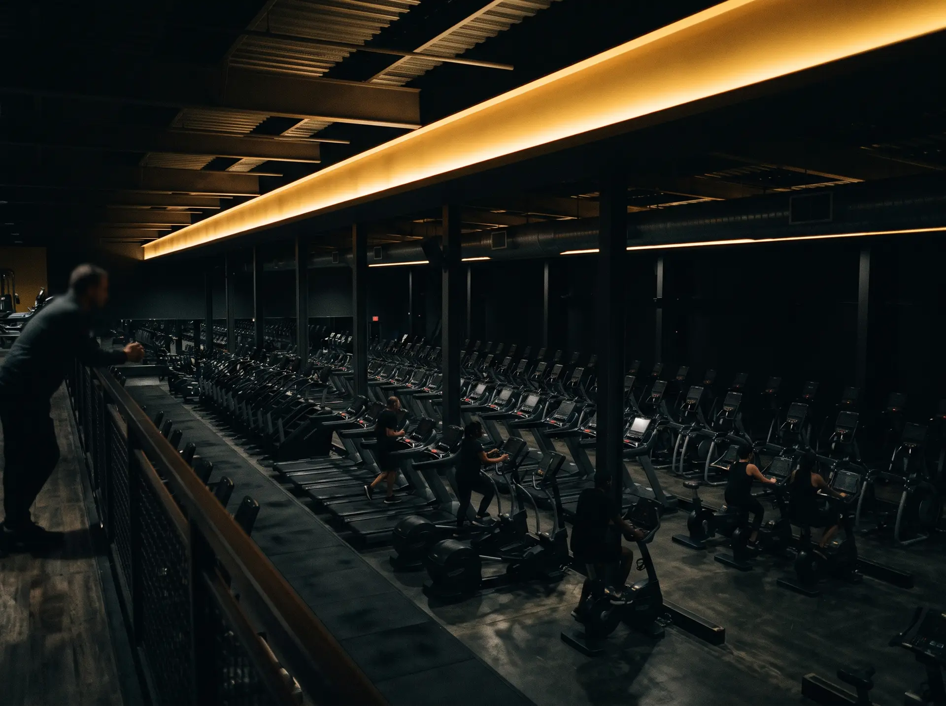 A large multi-site health club floor with members training